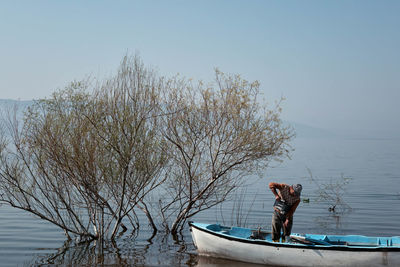 Man on boat over lake