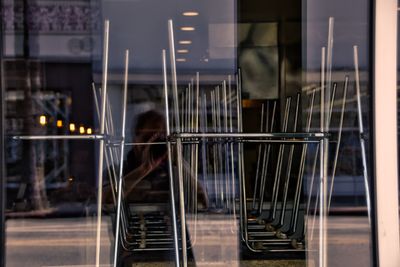 Man photographing with camera reflecting on window