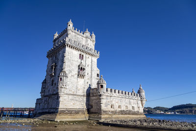 Low angle view of historical building against blue sky