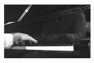 Close-up of man playing piano