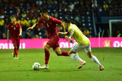 People playing soccer ball on grass