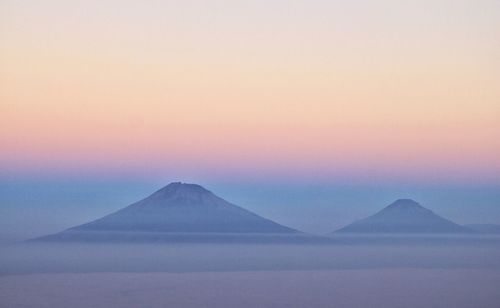 Scenic view of snowcapped mountains against sky during sunset