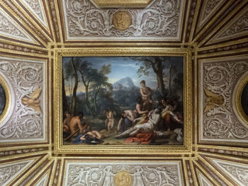 Low angle view of statues on ceiling of building