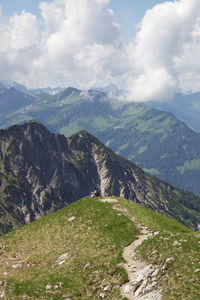 Scenic view of mountains against cloudy sky