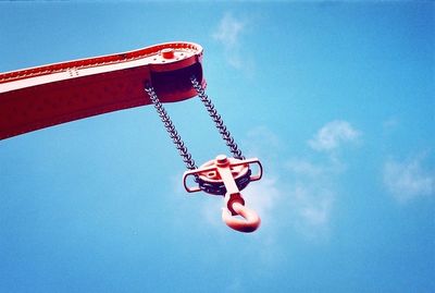 Low angle view of metal against blue sky