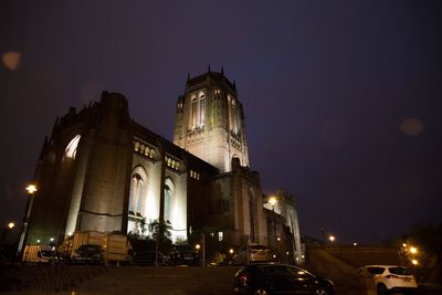 Low angle view of illuminated liverpool cathedral against clear sky at night