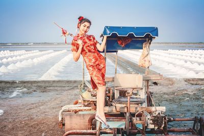 Full length of woman at beach against sky