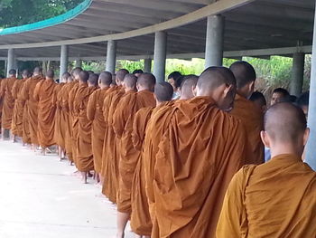 Rear view of men standing against temple