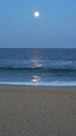 Scenic view of sea against clear sky at night