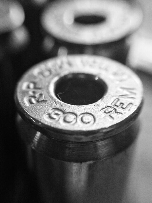 close-up, indoors, still life, single object, focus on foreground, number, metal, selective focus, communication, text, table, metallic, finance, old-fashioned, coin, circle, no people, technology, man made object, western script