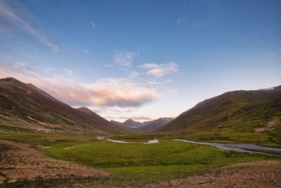 Scenic view of landscape and mountains against sky