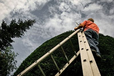 Low angle view of man standing on railroad track