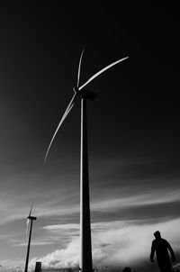 Low angle view of silhouette windmill against sky