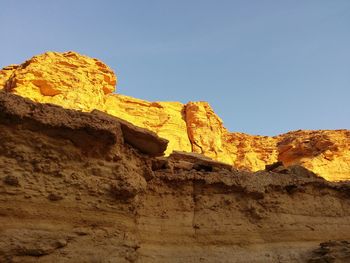 Low angle view of rock formation against sky