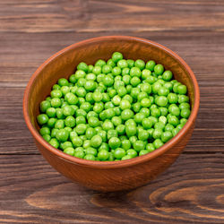 High angle view of green peas in bowl on table