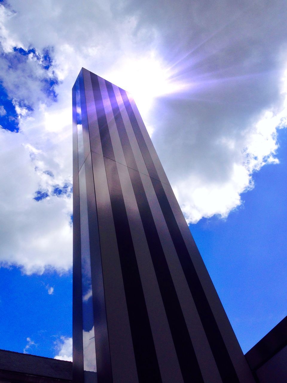 architecture, built structure, modern, building exterior, skyscraper, low angle view, sky, office building, city, tall - high, tower, cloud - sky, glass - material, reflection, blue, cloud, building, sunlight, day, capital cities