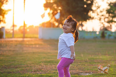 Side view of girl standing on grass