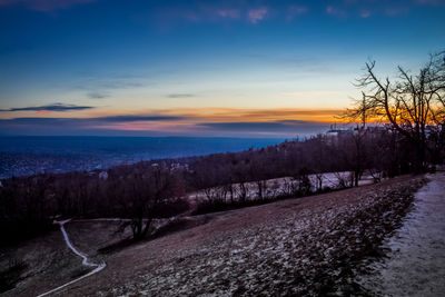 Scenic view of river against sky at sunset