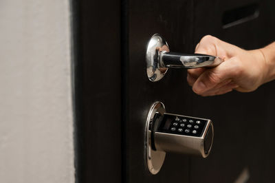 Cropped hand of person holding padlock