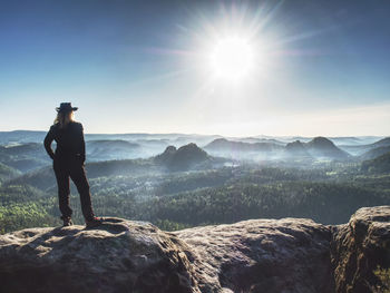 Rear view of man standing on rocks