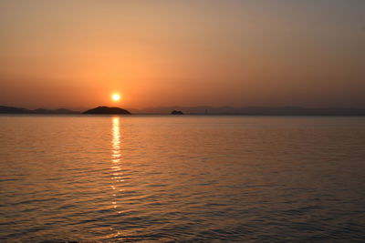 Scenic view of sea against romantic sky at sunset