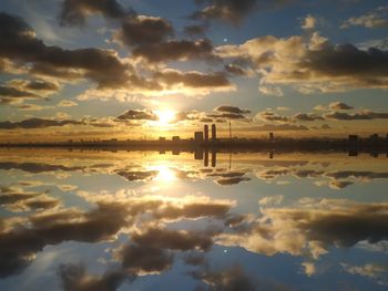 Scenic view of lake against sky during sunset