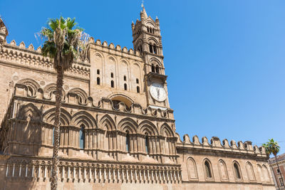 Low angle view of historic building against blue sky