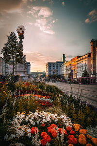 Buildings in city against sky during sunset