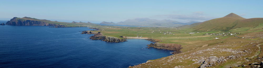 Scenic view of sea and mountains against sky