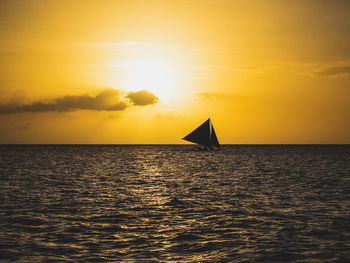 Scenic view of sea against orange sky