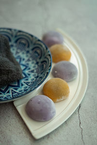 Multi-colored japanese mochi in rice dough on a beautiful plate. traditional japanese dessert.