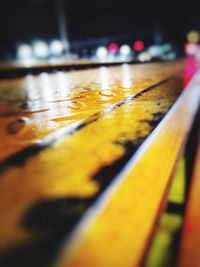 Close-up of wet yellow railing