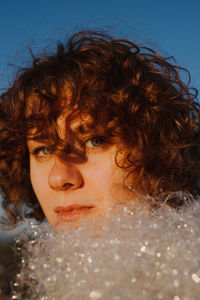 Close-up portrait of young woman looking away