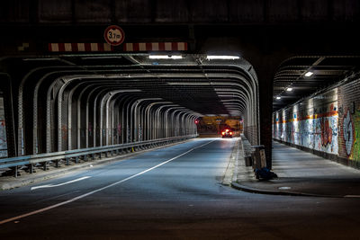 Illuminated road in city at night