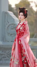 Portrait of young woman standing outdoors