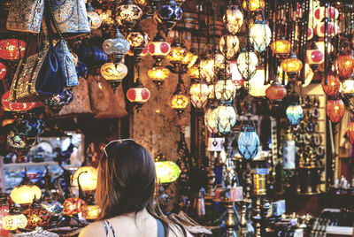 Rear view of woman in lantern shop at grand bazaar