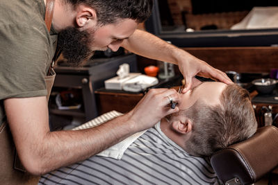 Side view of senior man giving massage