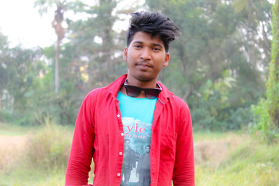 Portrait of young man standing on land