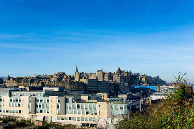 North bridge by buildings against blue sky