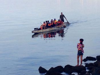 People in boat on lake