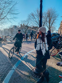 People riding bicycle on street in city