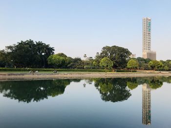 Reflection of trees and buildings in lake