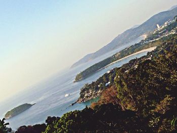 Scenic view of sea and mountains against sky