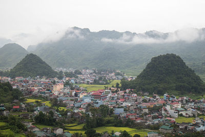 High angle view of townscape and mountains against sky