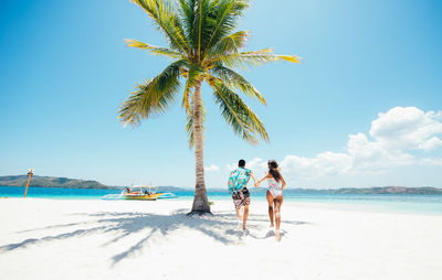 Couple at beach on sunny day