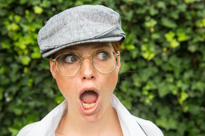 Shocked woman wearing eyeglasses looking away