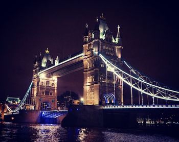 Low angle view of tower bridge over thames river at night