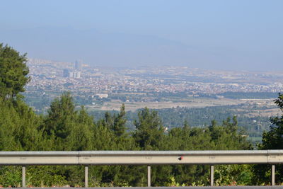 Scenic view of city and mountains against sky