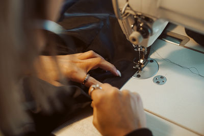 Midsection of person working at machine