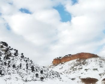 Low angle view of snowcapped mountain against sky